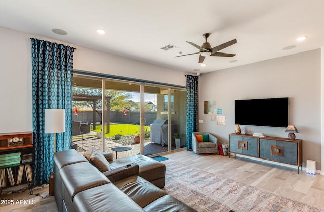 living room featuring ceiling fan and light wood-type flooring