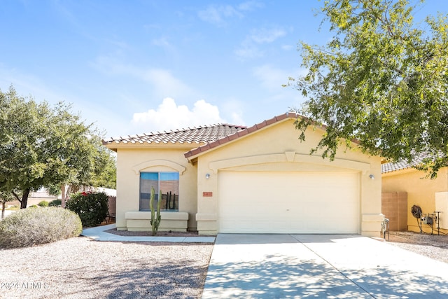 mediterranean / spanish-style house with a garage