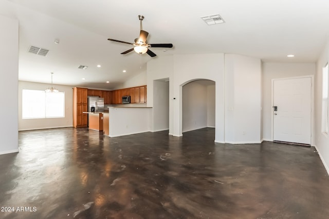 unfurnished living room featuring ceiling fan with notable chandelier and vaulted ceiling