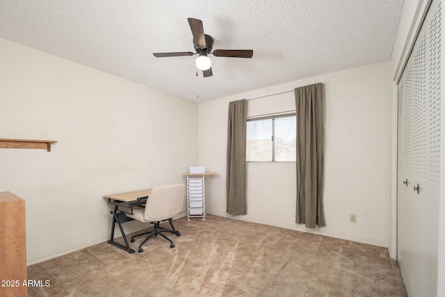 office space with a textured ceiling, ceiling fan, and carpet flooring