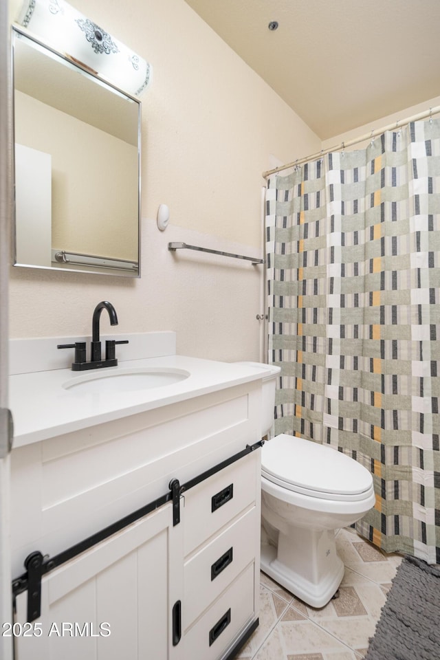 bathroom featuring tile patterned floors, toilet, and vanity