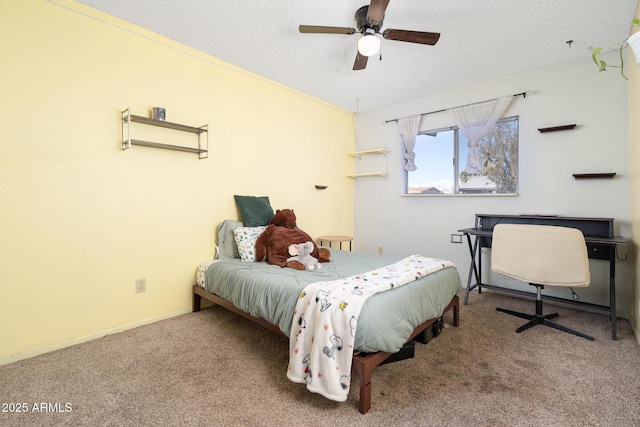 carpeted bedroom with baseboards, a textured ceiling, and ceiling fan