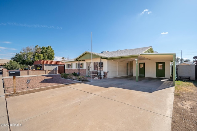 view of front facade with a carport and a garage