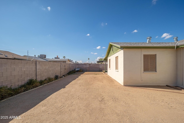 view of yard with cooling unit, a fenced backyard, and a patio area