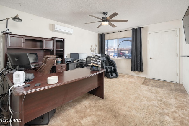 home office with a textured ceiling, ceiling fan, carpet, and a wall mounted AC