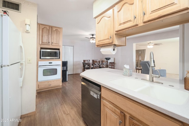 kitchen with visible vents, light brown cabinets, light countertops, appliances with stainless steel finishes, and a sink