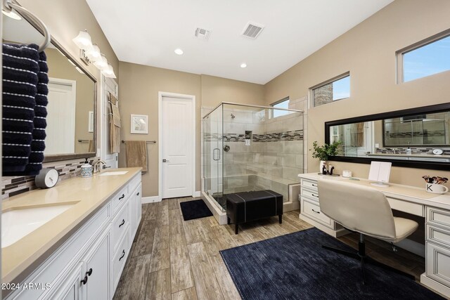 bathroom featuring walk in shower and vanity