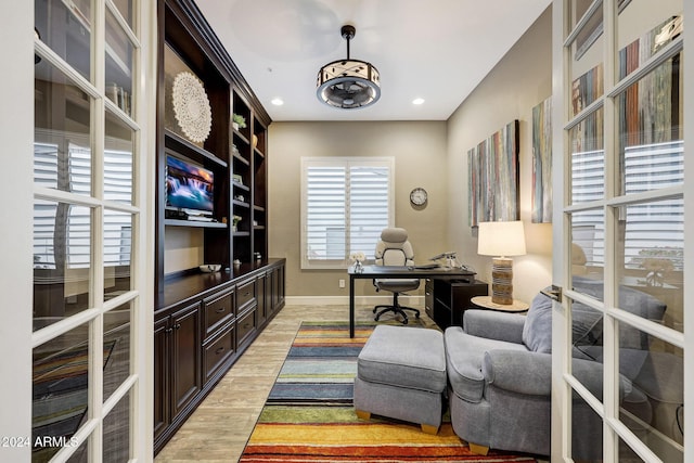 office with light hardwood / wood-style floors