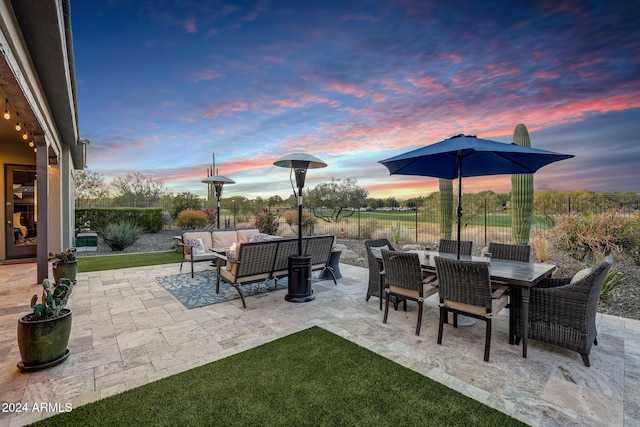 patio terrace at dusk featuring outdoor lounge area