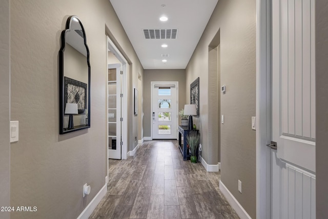 hall with wood-type flooring