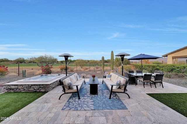 view of patio / terrace featuring an outdoor living space and an outdoor hot tub