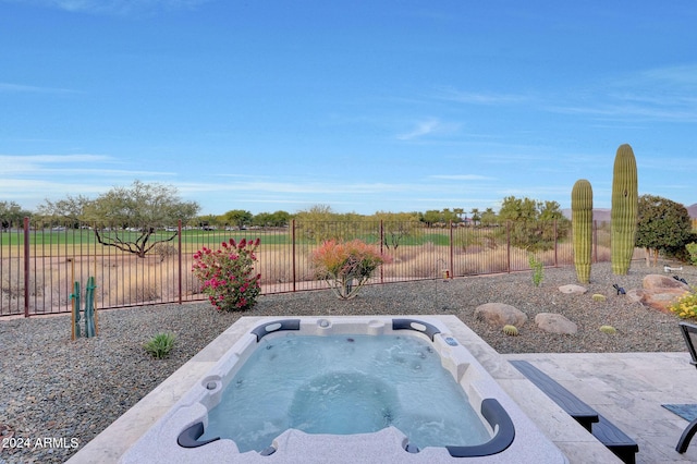 view of swimming pool featuring a hot tub