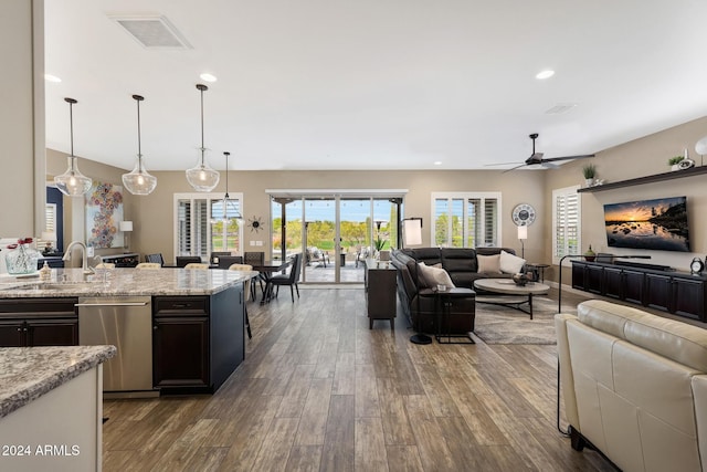 living room with ceiling fan, wood-type flooring, and sink