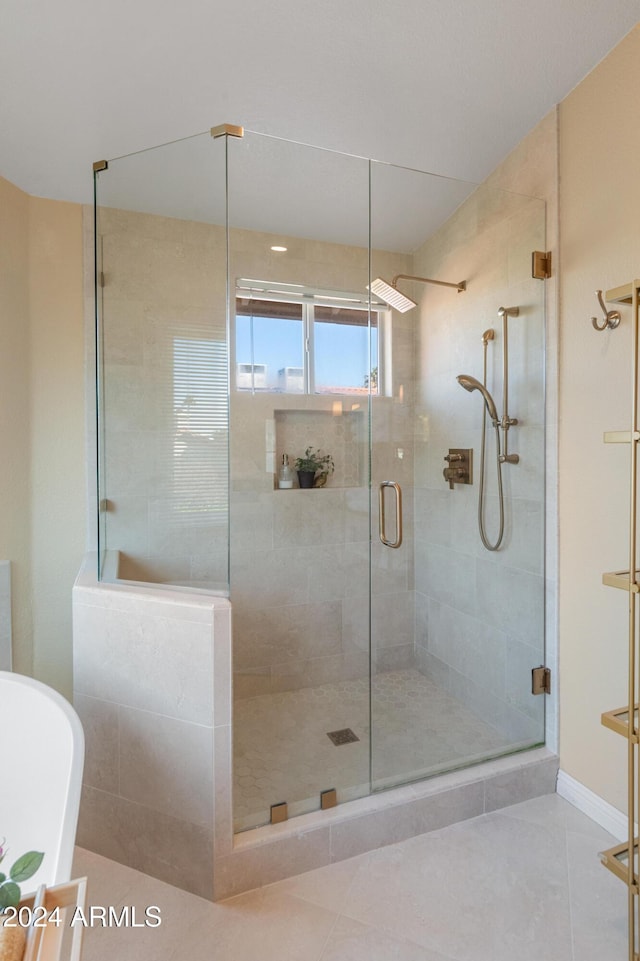 bathroom with separate shower and tub and tile patterned flooring