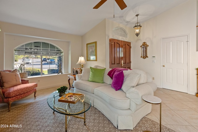 tiled living room featuring vaulted ceiling and ceiling fan