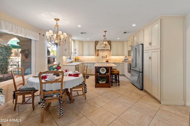 tiled dining room with a notable chandelier