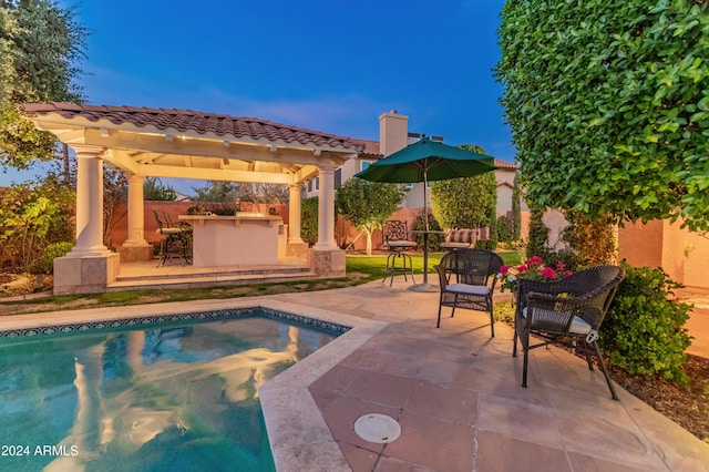 view of pool with a gazebo, an outdoor bar, and a patio