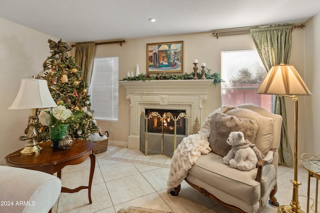 living area featuring a tile fireplace and light tile patterned floors