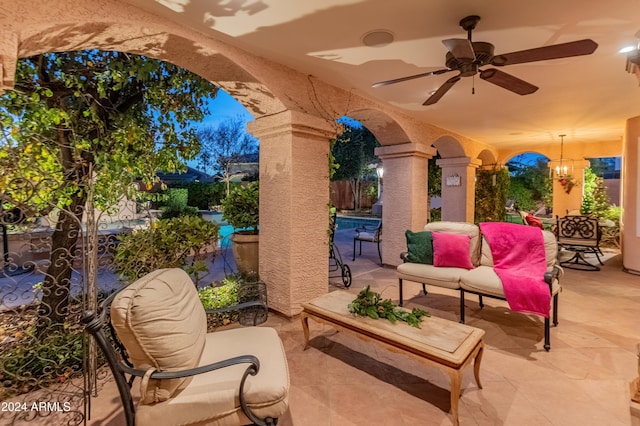 view of patio / terrace with ceiling fan and a swimming pool