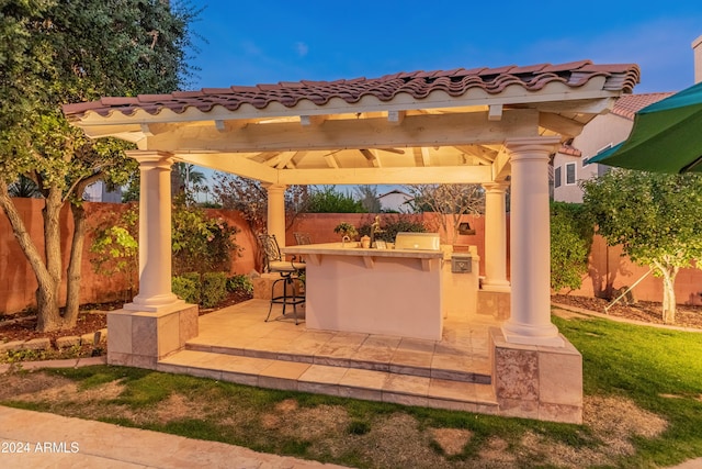 view of patio / terrace featuring a gazebo and an outdoor bar