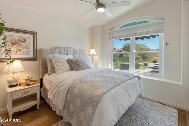 bedroom with wood-type flooring, ceiling fan, and lofted ceiling