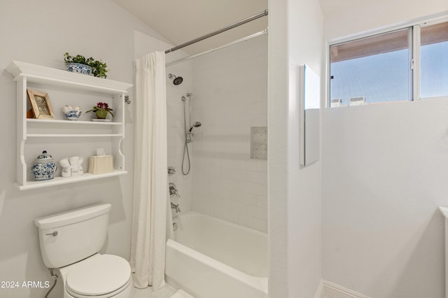 bathroom with shower / bath combo, toilet, and lofted ceiling