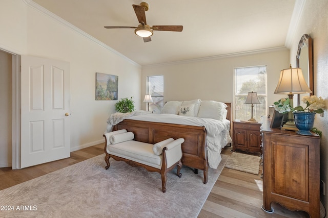 bedroom with ornamental molding, light hardwood / wood-style floors, ceiling fan, and lofted ceiling