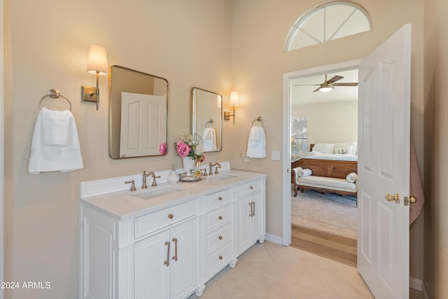 bathroom with tile patterned flooring, ceiling fan, plenty of natural light, and vanity