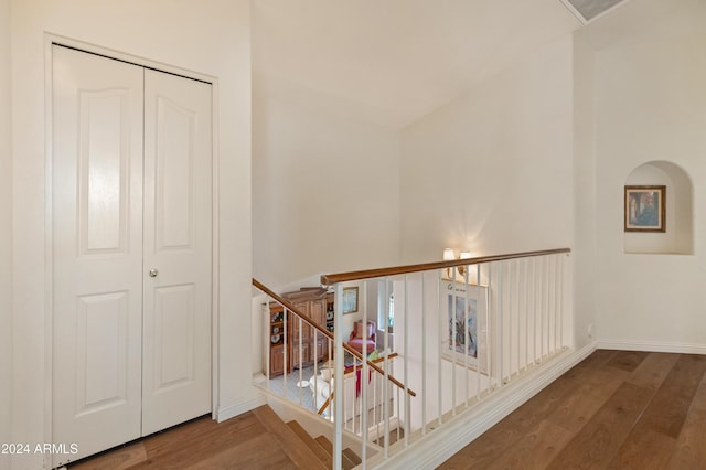 corridor with hardwood / wood-style flooring