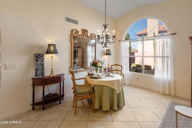 dining area featuring light tile patterned floors, a chandelier, and vaulted ceiling