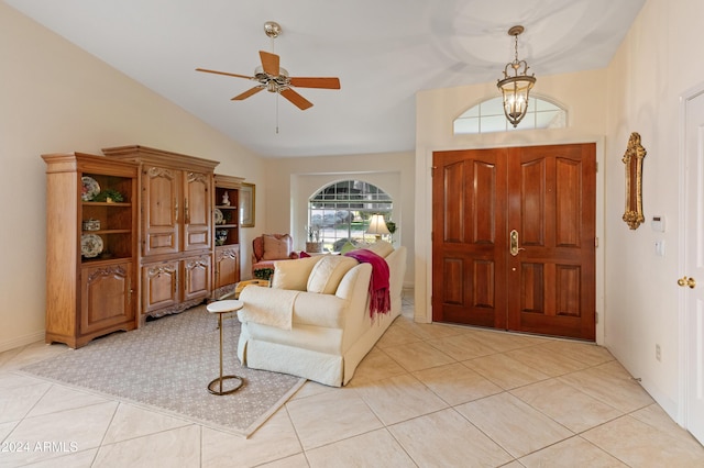 tiled entryway with ceiling fan and lofted ceiling