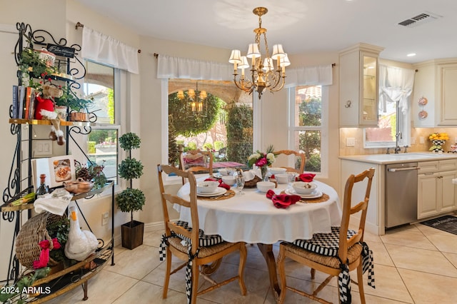 tiled dining area featuring a notable chandelier and sink