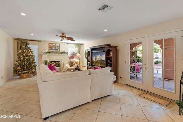 living room with ceiling fan, french doors, and light tile patterned floors