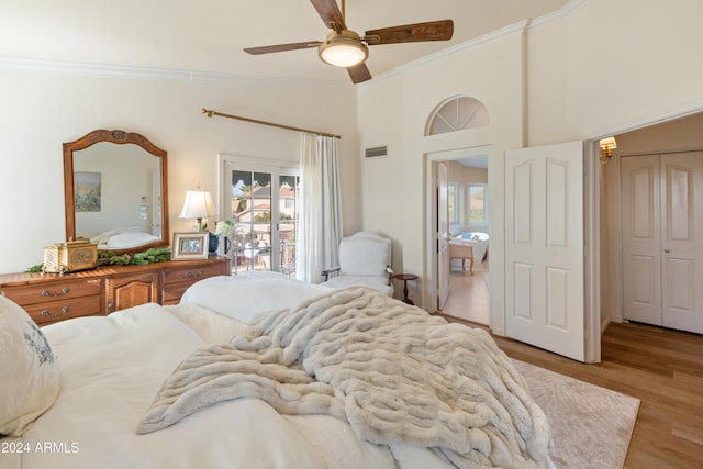 bedroom with ceiling fan, light wood-type flooring, ornamental molding, and a closet