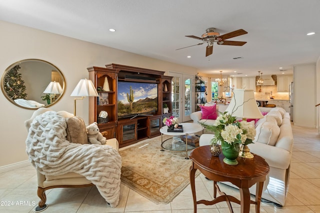 tiled living room featuring ceiling fan with notable chandelier