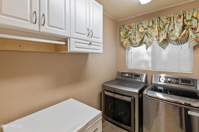 laundry room with cabinets and washing machine and dryer