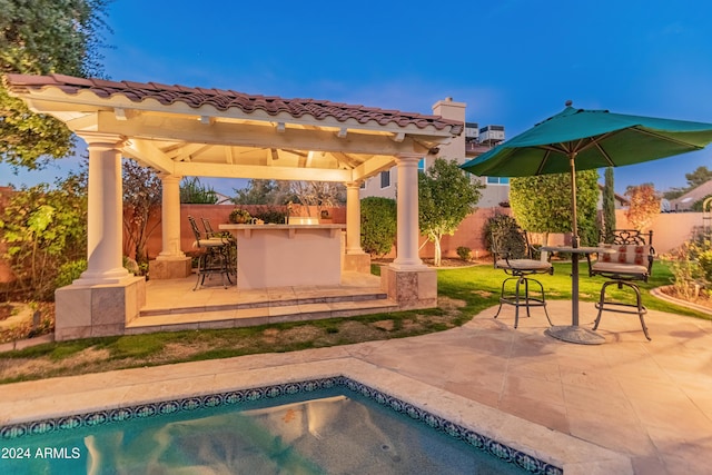 view of pool featuring a gazebo, exterior bar, and a patio