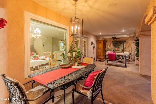 dining area with ceiling fan with notable chandelier