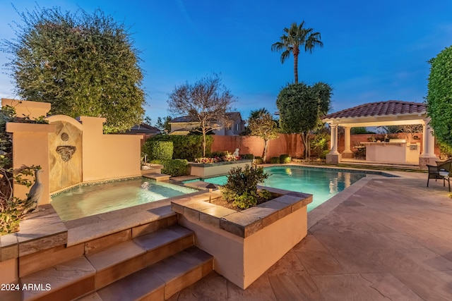 view of pool featuring a gazebo and an in ground hot tub