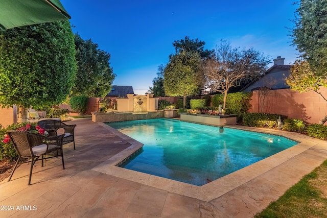 view of swimming pool featuring a patio area