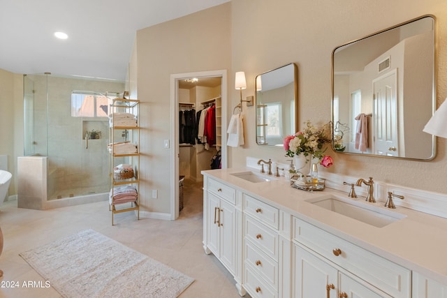 bathroom featuring tile patterned floors, vanity, and a shower with door