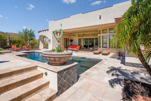 view of pool with a patio, an outdoor hangout area, and ceiling fan