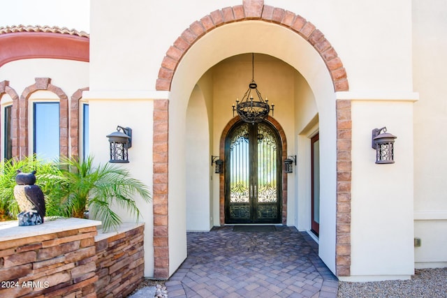 doorway to property featuring french doors and stucco siding