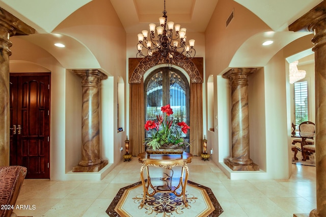 office featuring decorative columns, a chandelier, and light tile patterned floors