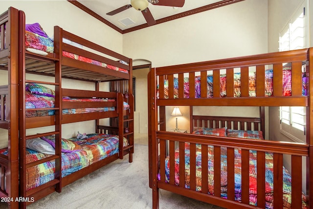 carpeted bedroom with multiple windows, visible vents, and crown molding