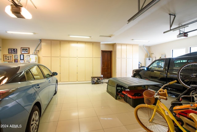 garage with a garage door opener and gas water heater