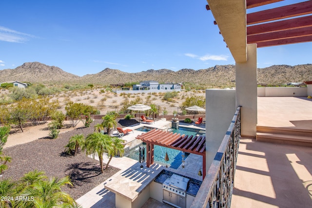 view of patio with a mountain view, area for grilling, a fenced in pool, and a pergola