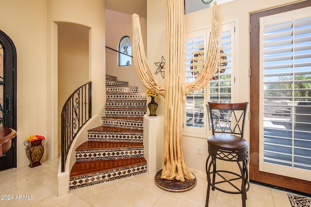 stairs featuring tile patterned floors