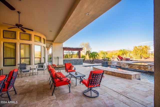 view of patio with a pergola, a mountain view, ceiling fan, a jacuzzi, and an outdoor pool