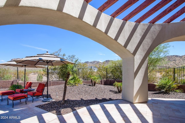 view of patio / terrace featuring a fenced backyard and a mountain view